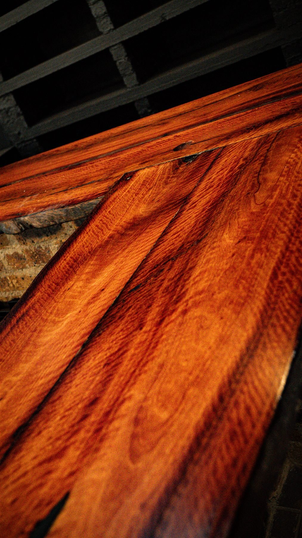 Stacked red hardwood slabs saw mill Benoni South Africa — De Jager Wood Designs